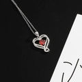 Silver heart pendant necklace featuring a bright red birthstone and white zircon accents - Bright Red (January)