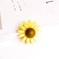 Detailed close-up of a sunflower pendant with yellow enamel petals on a white magazine - Yellow Sunflower Style (1#)