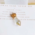 Macro detail of a golden crown and faceted iridescent crystal water drop pendant - Iridescent (9)