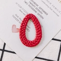 Macro view of red woven teardrop-shaped DIY earring charms with hollow resin texture - Rose Red