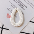 Primer plano de un colgante de gota blanco trenzado para joyería DIY con textura de ratán - Blanco