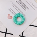 Close-up of mint green round woven resin pendant with fine braided texture for DIY jewelry - Sea Blue