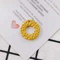 Detail of a round woven yellow pendant for DIY jewelry making with intricate texture - Yellow