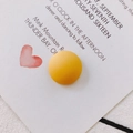 Macro shot of yellow matte resin round charms for DIY shoe accessories and jewelry - Yellow