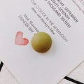 Detail view of a matte olive green resin semi-round patch on a decorative card background - Army Green