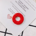 Detail shot of a red hollow round resin charm with intricate faux woven texture for jewelry DIY - Red