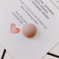 Close-up of matte resin round button accessory in dusty pink for DIY crafts - Purple