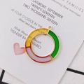 Detailed view of colorful geometric oil-drop round charms for DIY jewelry making - Yellow Purple Green Mixed