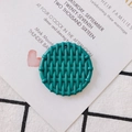Macro shot of circular teal resin charm with woven texture and top hole for DIY jewelry - Sea Green
