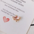 Detail of pink crystal semi-circle pendant with gold plated double rings and claw setting - Pink