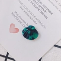 Detailed view of scallop-shaped acetate charms with green marble texture for DIY jewelry - Dark Green Marble