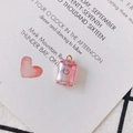 Macro view of a pink gradient rectangular crystal pendant with gold claw setting - Phantom Rose Purple