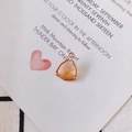 Macro shot of triangle champagne crystal pendant with gold plating for DIY jewelry making - Pink Orange