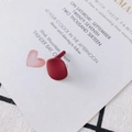 Detail of matte burgundy irregular geometric earrings with 925 silver pins on a card - Burgundy