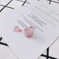Detail of matte pink circular earring studs with S925 silver pins on decorative card - Purple Pink