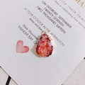 Close-up of teardrop resin pendant with red crystal texture and gold-plated metal edge - 4# Red Orange