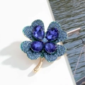 Elegant four-leaf clover brooch in blue crystals and gold-tone alloy frame - Blue