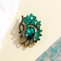 Elegant gold-tone brooch featuring a large green gemstone and vintage hollow patterns - Emerald Green (YLXZ-0047-green)