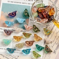 Macro view of colorful bird-shaped Czech glass beads with golden outlines for DIY jewelry - 1 Piece / Multicolor