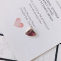 Macro shot of a purple fan-shaped crystal pendant with gold plating for jewelry making - Purplish Brown