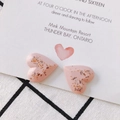 Detailed view of handmade pink heart resin earrings with golden leaf flakes on a white card - Pink