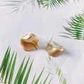 Macro shot of matte gold irregular wave-shaped stud earrings with palm leaf background - Wavy Petal Style (3#)