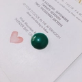 Macro shot of a green cabochon resin pendant for DIY jewelry making accessories - Dark Green