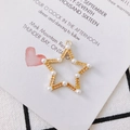 Star-shaped golden alloy pendant with textured finish and white faux pearl accents - Gold Star