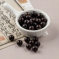 Polished 10mm dark brown round wood beads in a white bowl for DIY jewelry making - 1 Piece Pack / Black Brown