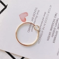 Minimalist interlocking double circles ring in golden finish on lifestyle card background - Double Circle Geometric Style (KP2262-1) / Style 1