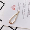 Close-up of polished gold teardrop charms with loop connectors on a creative background - Teardrop Geometric Style (KP2262-2) / 2#