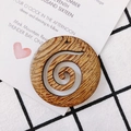 Detailed view of round wooden earring pendant with a hollow spiral cut-out pattern - Spiral Hollow Round (6#)