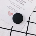 Flat round matte black DIY bead for earrings and pendants in a minimalist studio setting - Black