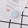 Matte light blue flat round bead accessory on wedding card with grid fabric background - Gray