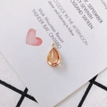 Teardrop pendant with golden metal frame and translucent orange resin for DIY jewelry - Champagne