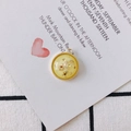 Macro detail of a round gold pendant with colorful inlaid shell pieces for jewelry DIY - Light Yellow