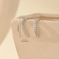 Macro shot of silver zircon curved earrings hooks with size specs on ceramic vase - White Gold Slightly Curved Pave Style (MYYX00580)