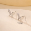 Macro shot of silver butterfly stud earrings with sparkling cubic zirconia stones - Platinum Butterfly Style (MYYX00652)