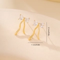 Detailed view of gold bow earrings with heart zircons and elegant flowing tassels - Gold Bowknot Tassel Style (MYYX00654)
