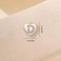 Detailed view of silver heart pendant with D initial and micro-set zircon crystals - Letter D-Platinum