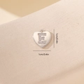 Dettaglio macro di un ciondolo a cuore argento con lettera E in zirconi cubici 1cm - Lettera E-Platino