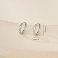 Close-up of silver geometric hoop earrings with star-shaped zircons and size markings - Star Engraved With Zirconia (E071305bkb) / White Gold