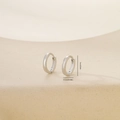 Detailed view of polished silver metal round hoop earrings with 1cm outer diameter dimensions - Minimalist Plain Hoop (E071398bkb) / Platinum (E071398bkb)