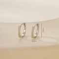Macro detail of geometric silver metal hoop earrings with precise size measurement labels - Rectangular Huggie (E071338bkb) / Platinum (E071338bkb)