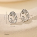 Detailed view of silver rose stud earrings with dimensions 1.7cm by 1.3cm on stone texture - Oval Frame Rose Style (MYYX00707(f-G26)) / White Gold