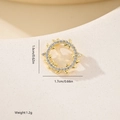 Macro shot of 1.6cm gold wreath pendant with leaves and white zircon stones - Hollow Leaf Wreath Style (MYXF0514) / Gold