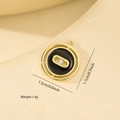 Detail showing 1.5cm round metal pendant with black enamel and small inset gemstone - Nested Round Pendant (XF0425) / Black with Gold Edge