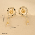 Macro shot of gold-plated snake earrings with white zircons and black enamel details - One Pair / Gold (MYWX22427)