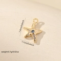 Macro shot of gold starfish pendant with blue gemstone and white zircon accents - Blue Zirconia Gold Sea Star (Gold MYCBK3650(i-I1))