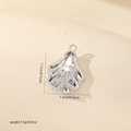 Macro detail of a silver shell pendant with zircon starfish inlay, size 1.7cm x 1.3cm - Silver Starfish Shell Style (MYCDNE545)